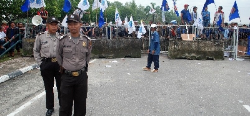 Sejumlah polisi bersiaga di gerbang kamp Chevron Pasific Indonesia (CPI) yang diblokir ratusan buruh di Pekanbaru. Para buruh memblokir gerbang kamp Chevron selama dua hari untuk mendesak perbaikan kontrak yang melindungi hak-hak buruh subkontraktor.