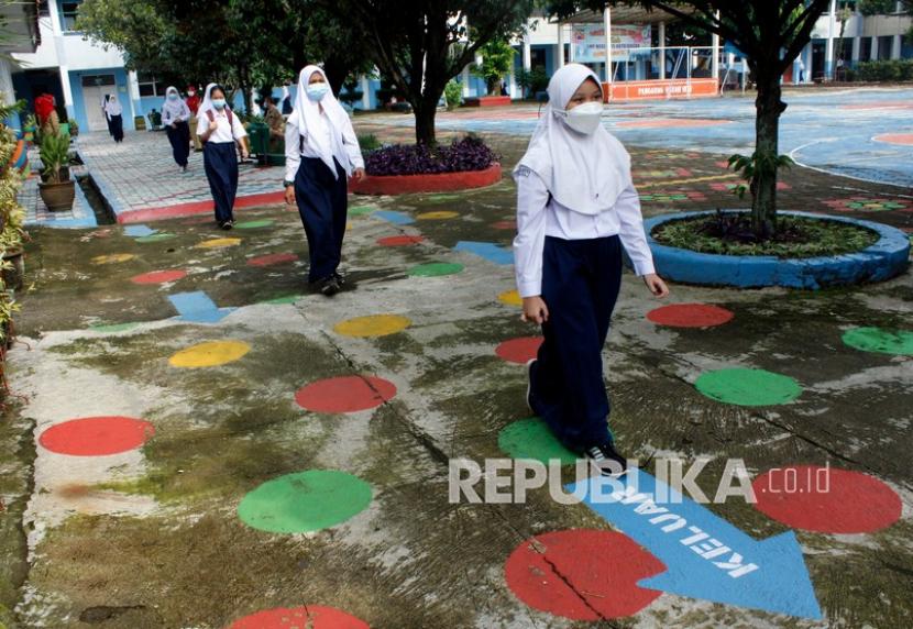 Sejumlah siswa berjalan dengan mengatur jarak saat uji coba pembelajaran tatap muka di SMPN 15 Kota Bogor, Jawa Barat. 