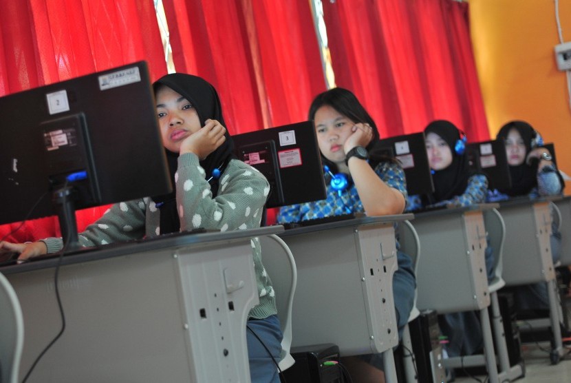 Sejumlah siswa mengerjakan soal menggunakan komputer saat simulasi Ujian Nasional Berbasis Komputer (UNBK) di SMK Negeri 7 Palembang, Sumatra Selatan, Kamis (25/2).