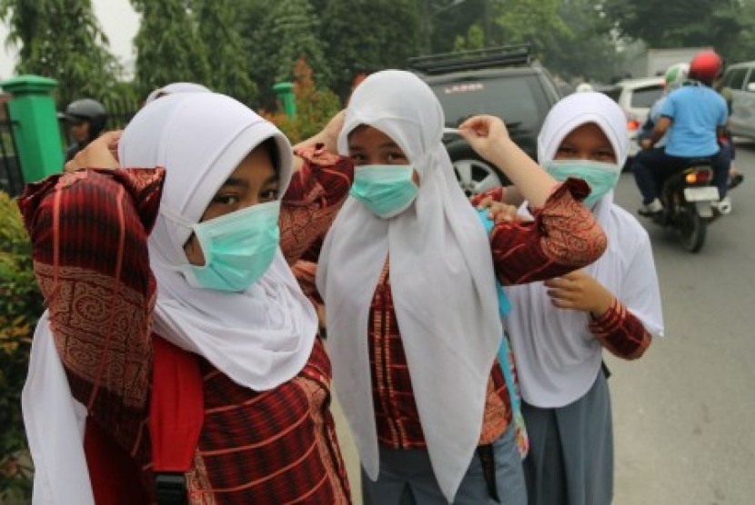 Sejumlah siswa SMA Negeri 2 Medan memakai masker yang dibagikan dinas kesehatan, di Medan, Sumatera Utara, Jumat (23/10). 