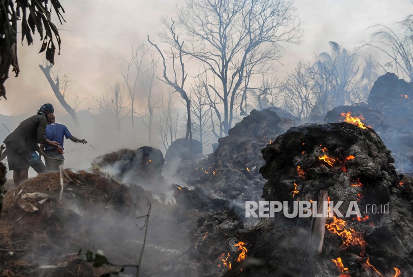 Sejumlah warga Baduy menyipratkan air untuk memadamkan api menggunakan alat seadanya saat terjadi kebakaran di Kampung Kadugede, Desa Kanekes, Lebak, Banten, Kamis (12/9/2019) sore. 