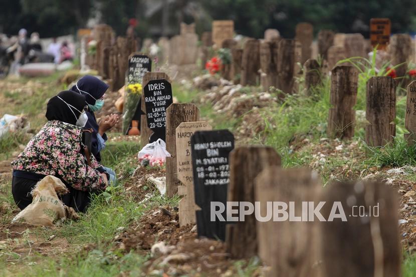 Sejumlah warga berziarah di area pemakaman khusus COVID-19 TPU Srengseng Sawah 2, Jakarta Selatan