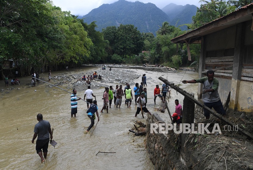 Sejumlah warga dan petugas mencari korban banjir bandang di reruntuhan bangunan di Kali Pos Tujuh, Sentani, Jayapura, Papua, Senin (18/3).