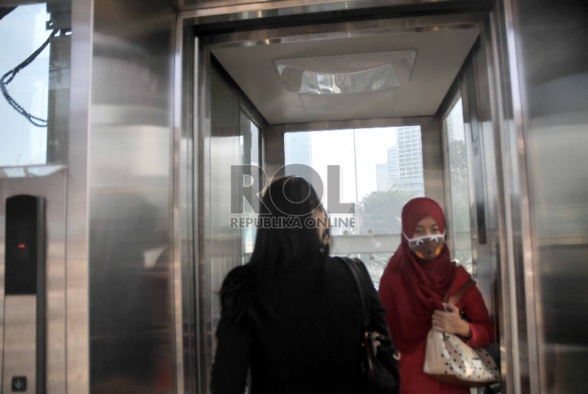 Sejumlah Warga memanfaatkan lift untuk menuju jembatan yang menghubungkan halte busway di Halte Busway Tosari, Jakarta Pusat, Senin (18/5). 