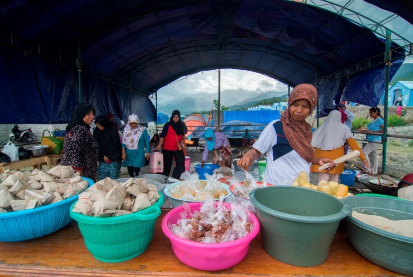 Sejumlah warga menyiapkan makanan di dapur umum Kamp Pengungsi Kelurahan Duyu, Palu, Sulawesi Tengah, Jumat (30/11/2018). 