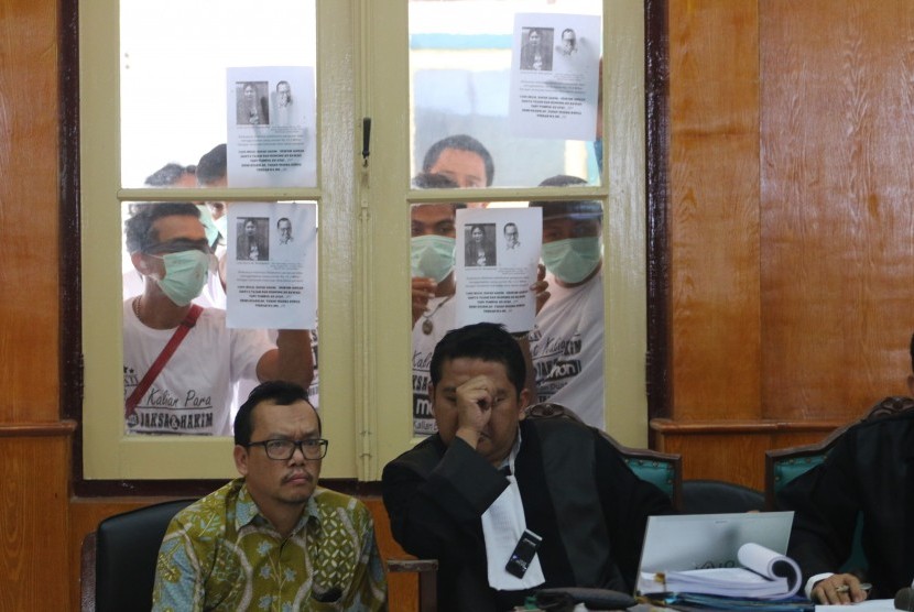 Sejumlah warga yang mengatasnamakan Serikat Kerakyatan Indonesia (belakang) memegang poster ketika mengikuti sidang kasus dugaan penggelapan uang politikus Partai Demokrat, Ramadhan Pohan, di Pengadilan Negeri Medan, Sumatera Utara, Selasa (31/1). 