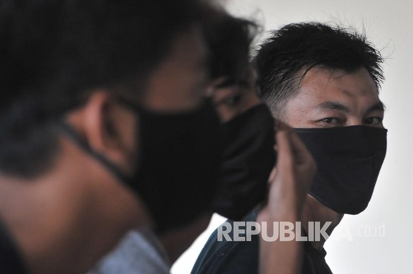 Sejumlah warga yang terjaring karena tidak mengenakan masker dikumpulkan di Asrama Haji Palembang Sumsel, Kamis (30/4/2020). Sekitar 32 orang warga di Kota Palembang terjaring oleh tim Satgas saat razia keamanan COVID-19 karena tidak memakai masker pada hari pertama dengan penerapan sanksi berupa karantina selama 24 jam di Asrama Haji Palembang. 