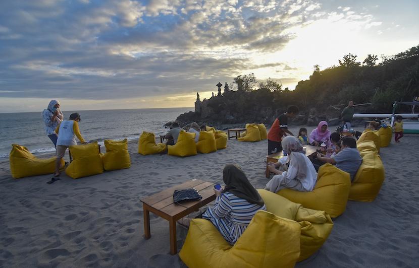 Sejumlah wisatawan menikmati suasana menjelang senja di Pantai Batu Bolong, Senggigi, Lombok Barat, NTB, Sabtu (23/7/2022). Jumah kunjungan wisatawan mancanegara ke Indonesia pada Juni naik 62 persen.