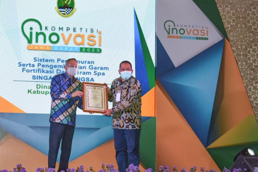 Sekda Provinsi Jabar Setiawan Wangsaatmaja (kiri) menyerahkan penghargaan kepada Pemkab Karawang dalam ajang Kompetisi Inovasi Jawa Barat (KIJB) 2020 di Trans Luxury Hotel, Kota Bandung, Selasa (15/12).   