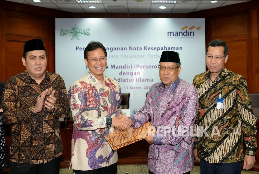 Sekjen PBNU Helmy Faishal Zaini, Dirut Bank Mandiri Budi G Sadikin, Ketua Umum PBNU KH Said Aqil Siradj dan Direktur Micro&Business; Banking Bank Mandiri Tardi usai melakukan penandatangan kerjasama layanan jasa keuangan perbankan di Jakarta, Kamis (17/3).