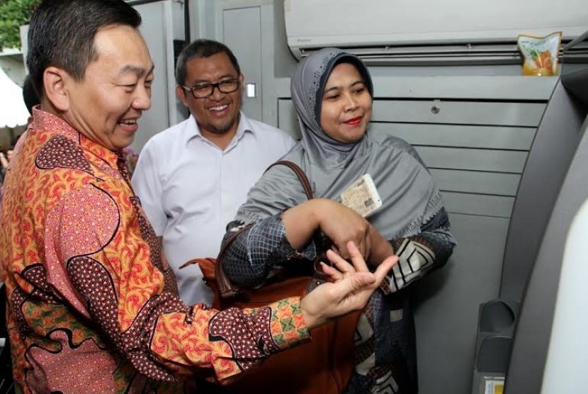 Senior General Manager Head of Consumer Card PT Bank Central Asia Tbk (BCA) Santoso (kiri) sedang memberikan penjelasan transaksi kepada masyarakat terkait dengan pembayaran Pajak Kendaraan Bermotor (PKB) untuk Provinsi Jawa Barat melalui ATM BCA disaksika