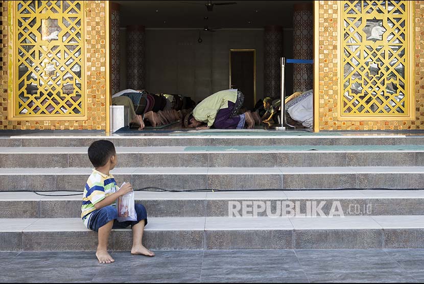 Hanya Rp 25 Ribu Bisa Bantu Renovasi Masjid se-Denpasar. Seorang anak memperhatikan umat Islam shalat  berjamaah di sebuah masjid di Denpasar.