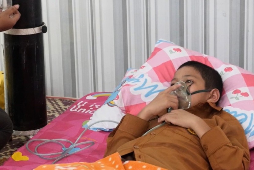 Seorang anak sedang mendapatkan perawatan akibat terpapar kabut asap di kawasan Riau.
