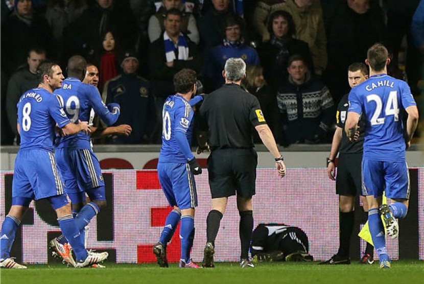 Seorang ball boy (tiga kanan) tersungkur di lapangan setelah terlibat insiden dengan pemain Chelsea, Eden Hazard (tak terlihat) dalam leg kedua semifinal Piala Liga lawan Swansea City di Stadion Liberty, Wales, Rabu (23/1). 