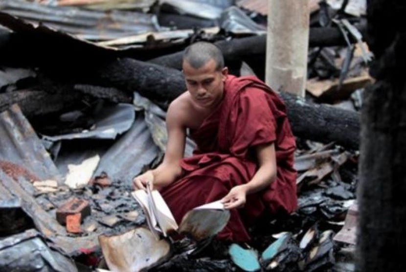 Seorang biksu Buddha Bangladesh memeriksa sisa-sisa buku agama yang terbakar habis bersama kuil Buddha dalam serangan hari Sabtu dan Minggu di Ramu, wilayah Cox's Bazar, Bangladesh (1/10).
