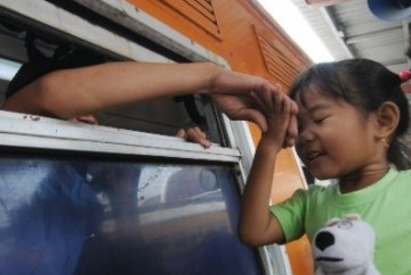Seorang bocah mencium tangan saudaranya yang akan pergi menggunakan kereta api kelas ekonomi Gaya Baru di Stasiun Jakarta Kota, Jakarta Barat, Senin (22/8). Mulai 23 Agustus hingga 3 September 2011, kereta api kelas ekonomi angkutan Lebaran dari Jakarta ha