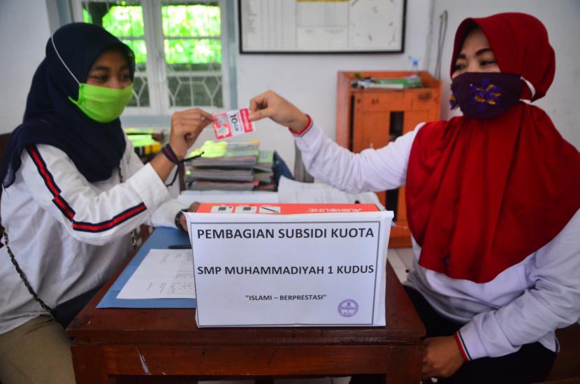 Seorang guru memberikan kuota kepada siswa saat pembagian subsidi kuota di SMP Muhammadiyah 1 Kudus, Kudus, Jawa Tengah, Pemberian kuota untuk menunjang kelancaran proses belajar secara daring di tengah pandemi Covid-19 yang menggunakan dana BOS.