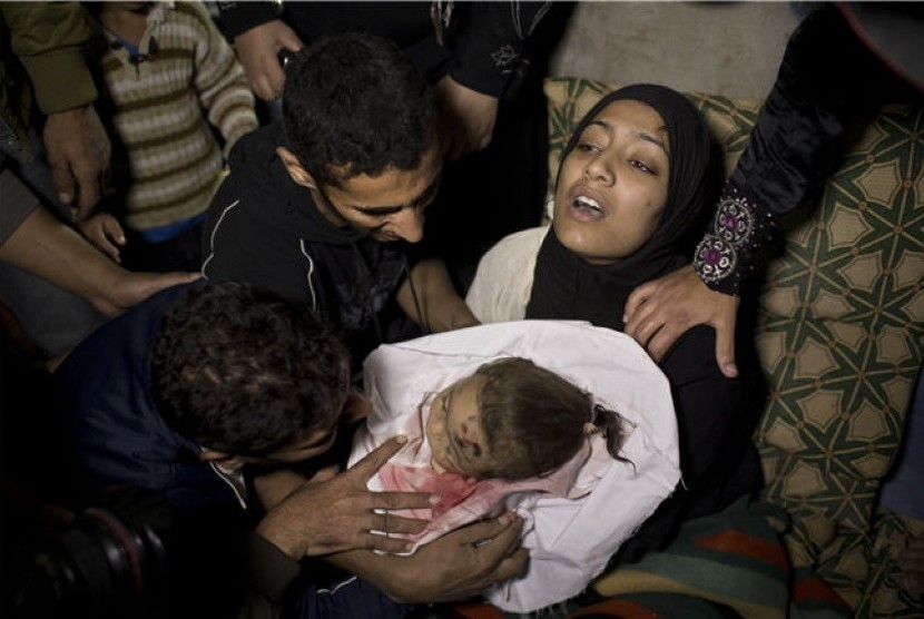 Seorang ibu menggendong jasad anaknya yang tewas dalam serangan Israel di Jabaliya, Jalur Gaza, Palestina, Jumat (16/11). 