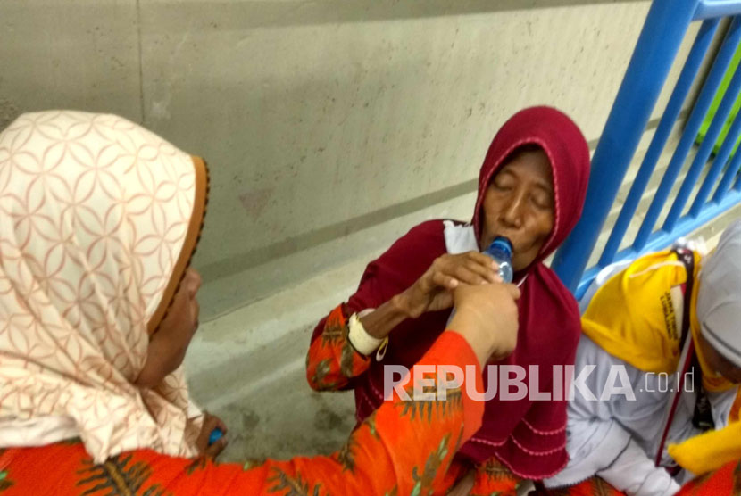 Seorang jamaah haji asal Lumajang duduk di terowongan karena merasa kelelahan usai berjalan kaki dari jamarat (Ilustrasi). (Republika/Amin Madani)