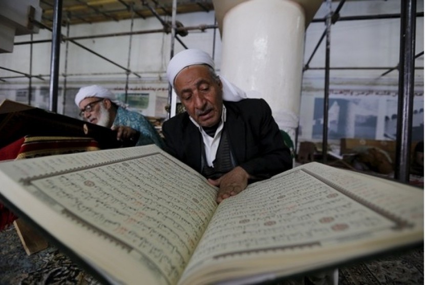 Seorang kakek membaca Al Quran di Yaman.