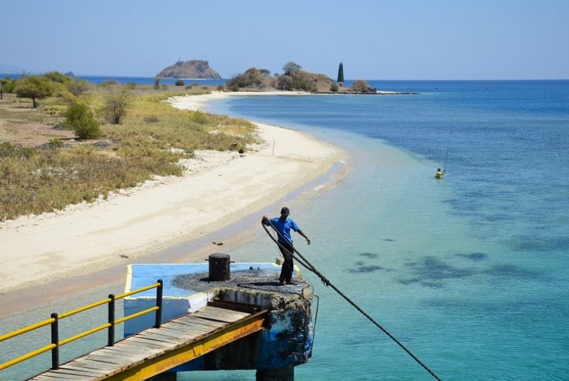 Seorang laki-laki menarik tali tambatan kapal feri usai melintasi Selat Alas dan berlabuh di pelabuhan Poto Tano, Taliwang, Sumbawa Barat, NTB, Minggu (10/9).