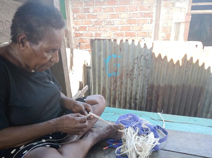 Seorang mama Papua, Lementina Abayaka, membuat dari noken dari kulit kayu melinjo.