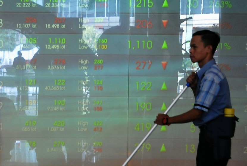 Seorang melintas di depan layar Grafik Indeks Harga Saham Gabungan (IHSG) di Bursa Efek Indonesia, Jakarta, Senin (4/8).