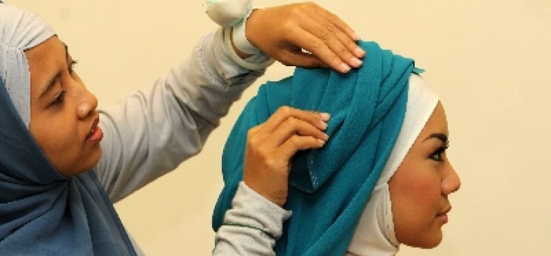 seorang model mengenakan kreasi jilbab pasmina