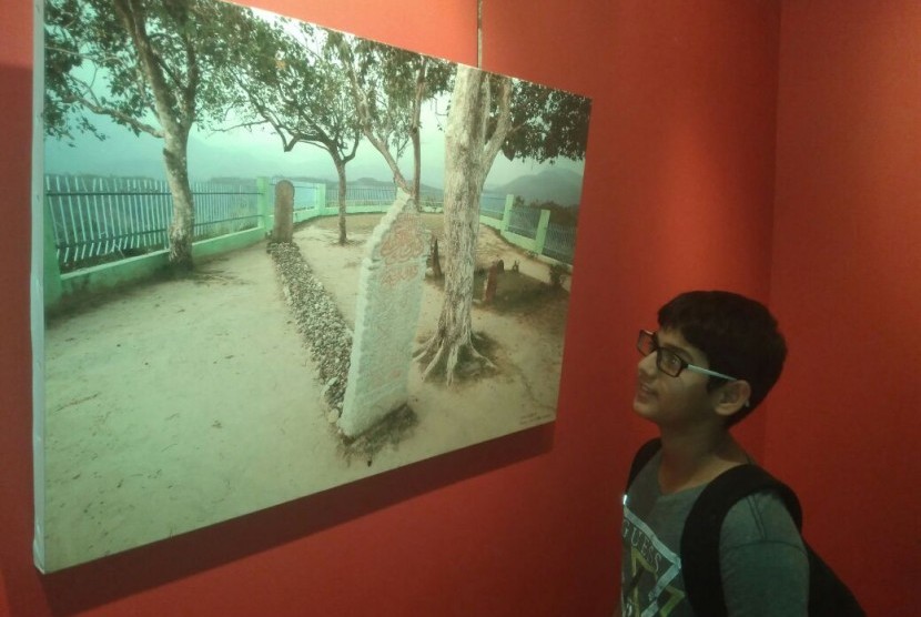 Seorang pengunjung memperhatikan foto karya Hasiholan Siahaan tentang Barus saat pameran foto bertajuk 'Barus Kota Emporium dan Peradaban Nusantara' di Pusat Kebudayaan Prancis, Jakarta, Sabtu (19/5). 