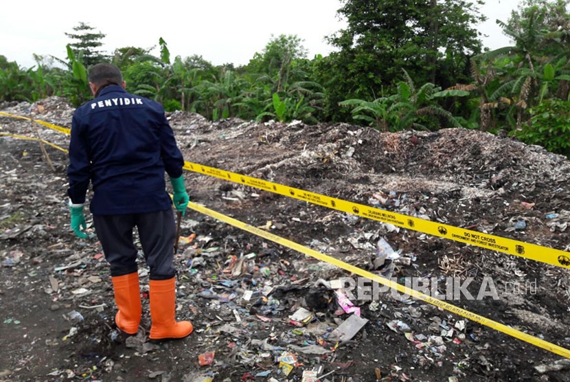 Seorang penyidik dari Gakkum KLHK sedang mengambil sampel limbah medis yang dibuang di tempat pembuangan sampah liar Desa Panguragan Wetan, Kamis (14/2).