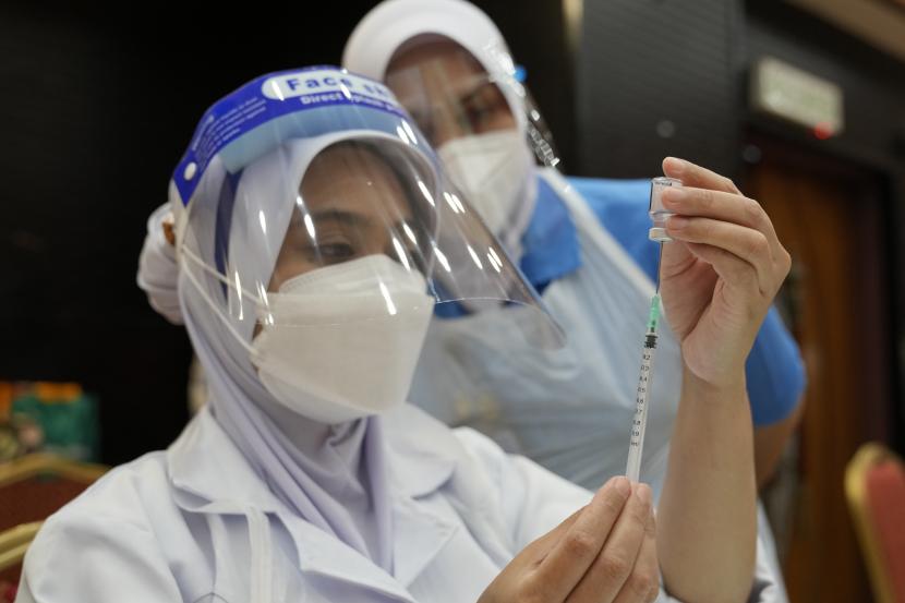 China Donasikan 500 Ribu Dosis Vaksin untuk Malaysia. Seorang perawat menyiapkan dosis vaksin Pfizer terhadap penyakit virus corona (COVID-19) untuk siswa sekolah menengah di pusat vaksin di Shah Alam, Malaysia, Senin, 20 September 2021.