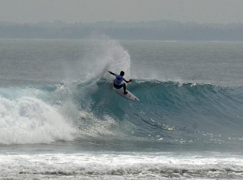 Seorang peselancar yang juga peserta World Surf League (WSL) Krui Pro 2022 beraksi di atas ombak pantai Tanjung Setia di Kabupaten Pesisir Barat, Lampung, Sabtu (11/6/2022). Ajang kejuaraan selancar Internasional tersebut diikuti oleh 216 peselancar dari 17 negara yang berlangsung hingga 17 Juni 2022. 