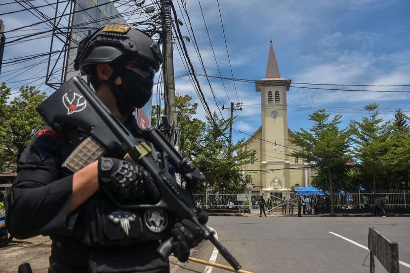 Seorang petugas polisi berjaga-jaga setelah ledakan di Makassar, Indonesia, pada hari Minggu.
