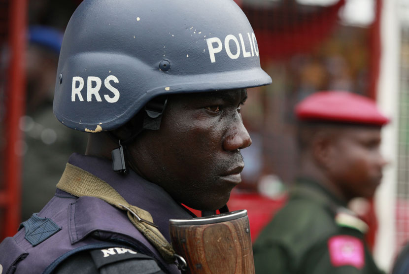 Seorang polisi mengamankan aksi unjuk rasa memprotes penculikan anak yang dituduhkan dilakukan oleh kelompok Boko Haram di Lagos, Nigeria. 