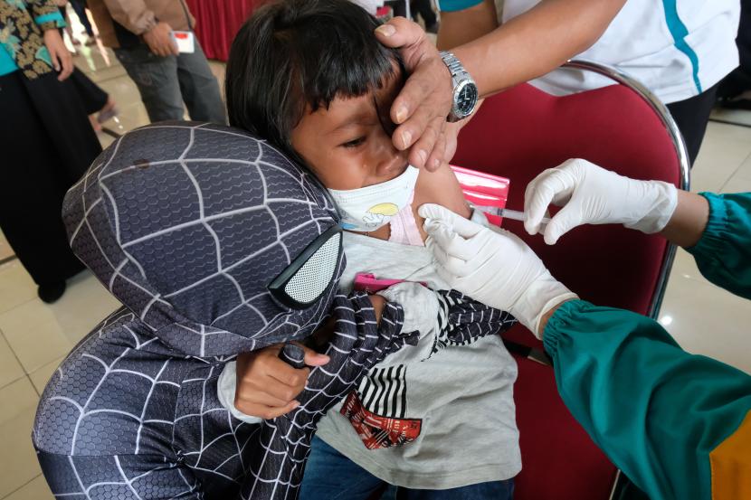 Seorang relawan berpakaian Spiderman mendampingi siswa saat vaksinasi COVID-19 bagi anak umur 6-11 tahun di Muntung, Candiroto, Temanggung, Jawa Tengah, Sabtu (29/1/2022). Kehadiran relawan berpakaian super hero pada vaksinasi COVID-19 yang diselenggarakan oleh Badan Intelejen Negara (BIN) tersebut guna menghibur anak-anak dan memberi semangat agar tidak takut saat disuntik