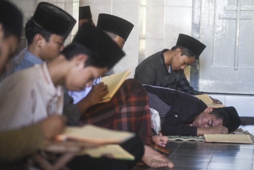Seorang santri tertidur ketika mengaji Kitab Kuning di komplek Pondok Pesantren (Ponpes) Lirboyo, Kediri, Jawa Timur, Selasa (30/5).
