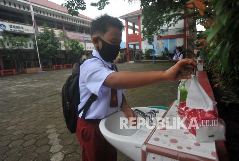 Seorang siswa mencuci tangan sebelum masuk ke kelas, di SDN 06 Lapai, Padang, Sumatera Barat, Senin (4/1). Epidemiolog dari Universitas Andalas (Unand) SumateraBarat Defriman Djafri mengatakan 3T dan 3M harus terus diperkuat sebagai strategi pengendalian dan pencegahan penularan COVID-19. 