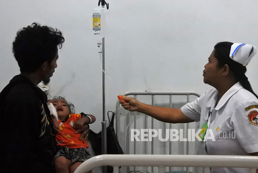 Seorang suster mengecek cairan infus salah seorang pasien yang dirawat akibat terserang demam berdarah dengue (DBD). 