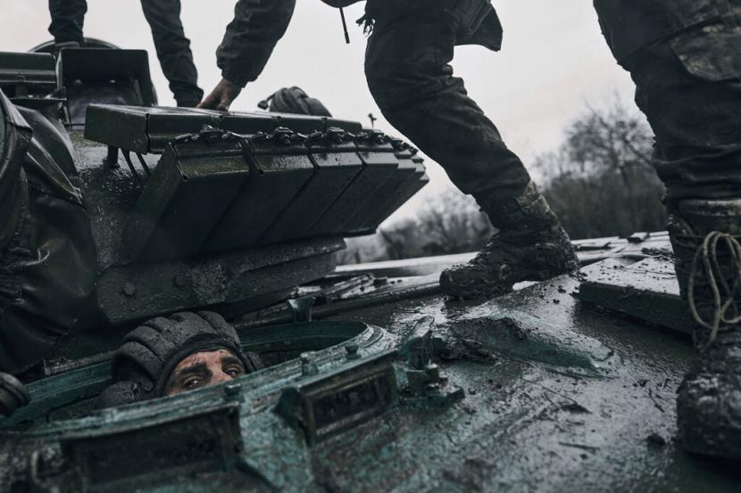 Seorang tentara Ukraina mengintip dari tank Rusia yang ditangkap di garis depan di wilayah Donetsk, Ukraina, Selasa, 22 November 2022.