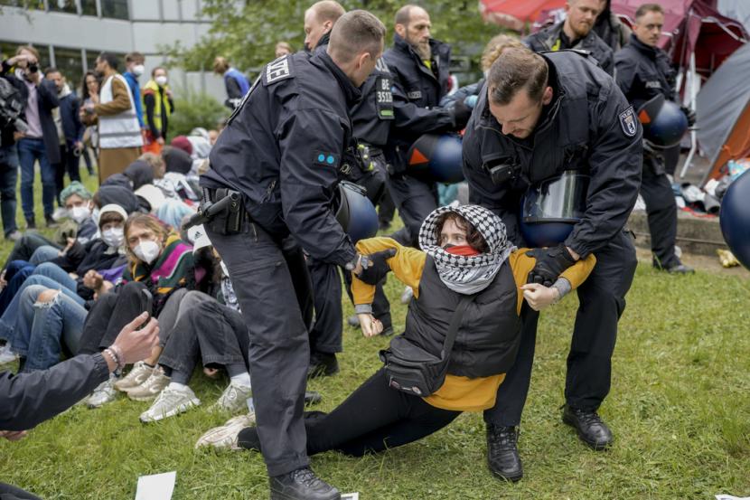 Seorang wanita dibawa oleh petugas polisi saat demonstrasi pro-Palestina oleh kelompok Student Coalition Berlin di halaman teater universitas Freie Universität Berlin di Berlin, Jerman, Selasa, 7 Mei 2024.
