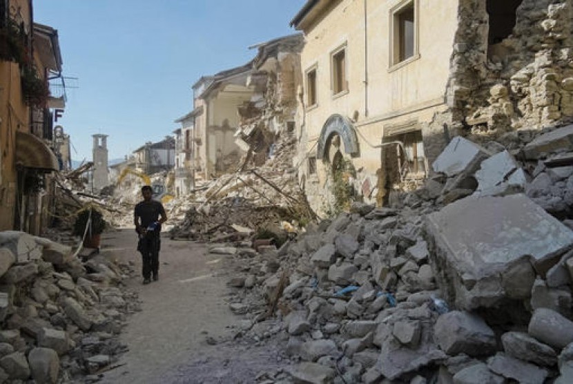 Seorang warga berjalan di jalanan Amatrice, Italia tengah usai diguncang gempa 6,2 SR, Rabu, 24 Agustus 2016.