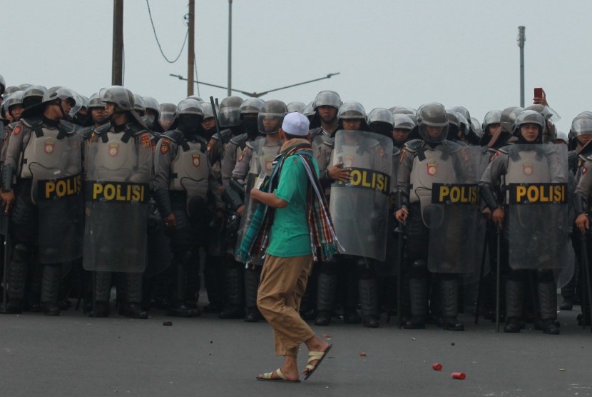 Seorang warga melintas di depan blokade kepolisian di atas jalan layang Slipi Jaya, Jakarta, Rabu (22/5/2019).