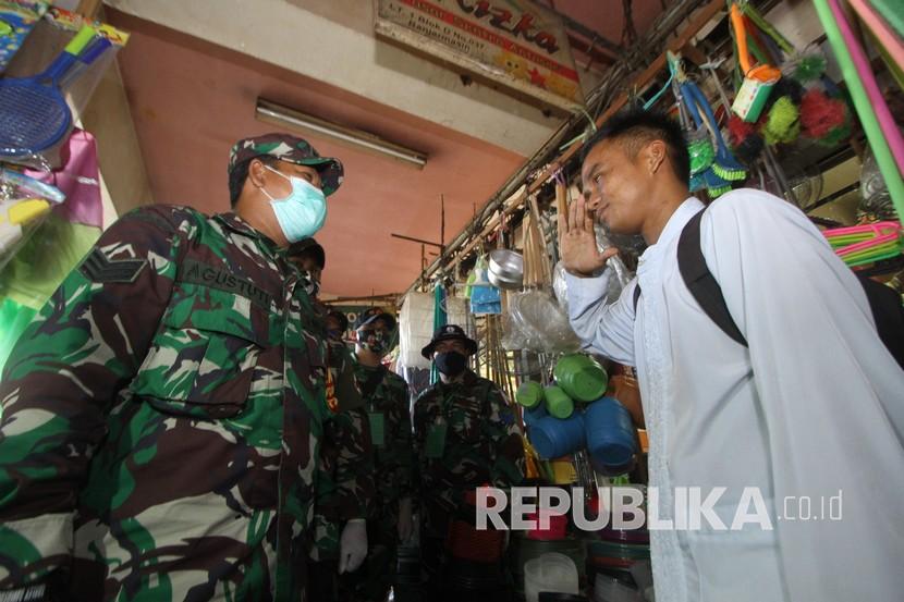 Seorang warga menerima sanksi mengucapkan Pancasila karena tidak menggunakan masker. 