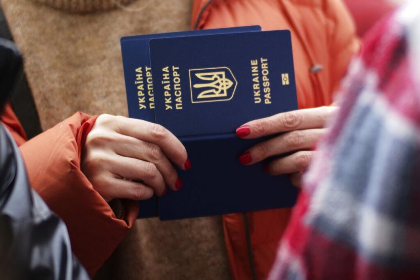 Seorang warga Ukraina memegang paspor sambil menunggu bus yang akan membawanya ke Jerman, di Przemysl, Polandis, Kamis (3/3/2022). Politikus Spanyol: Pengungsi Ukraina Harus Diterima, Kecuali Muslim