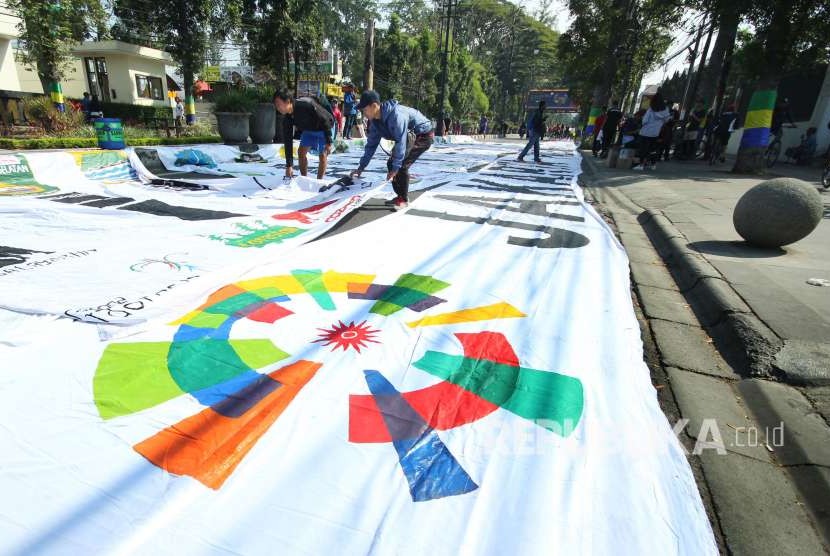 Sepanjang 50 meter sepandung bertuliskan Asian Games 2018 dibentangkan kelompok pecinta alam Nusalayaran, di Car Free Day (CFD) Dago, Kota Bandung, Ahad (5/8). 