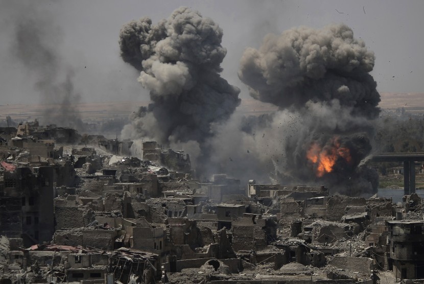 Air strikes hits the edge of the old city a day after the Iraqi prime minister declared a total victory in Mosul, Iraq, on Tuesday (July 11).