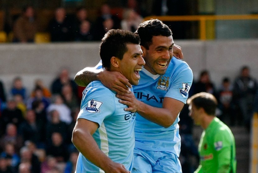 Sergio Aguero, kiri, saat merayakan golnya bersama Carlos Tevez saat timnya Manchester City menghadapi Wolverhampton Wanderers di Molineux Stadium, Wolverhampton, Inggris, Ahad (22/4)