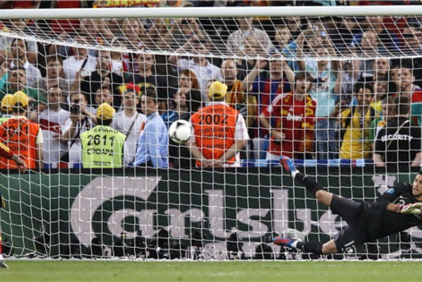 Sergio Ramos (kiri), bek timnas Spanyol, melepaskan tembakan 'penalti Panenka' dalam duel penalti lawan Portugal di semifinal Piala Eropa 2012. 