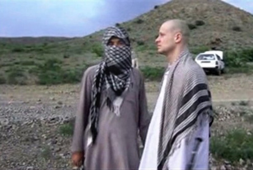 Sgt. Bowe Bergdahl (right) stands with a Taliban fighter in eastern Afghanistan.