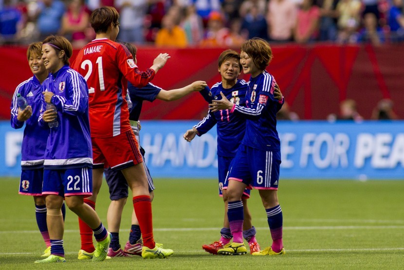 Shinobu Ohno (C) and Mizuho Sakaguchi (R) of Japan celebrate at the end of the FIFA Women's World Cup 2015 Round of 16 match between Japan and the Netherlands in Vancouver, Canada, 23 June 2015. Japan won